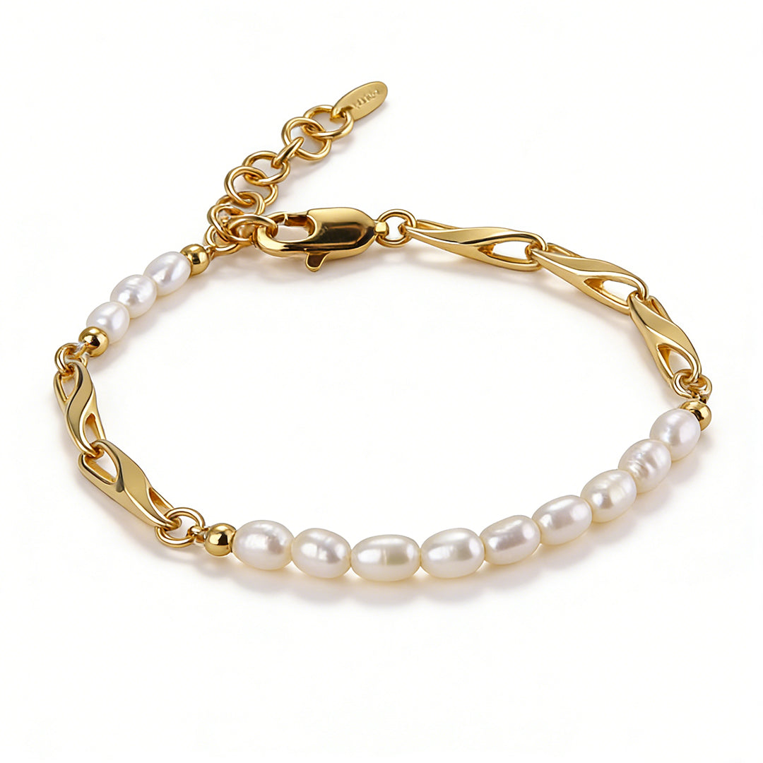 A minimalist gold pearl bracelet featuring a sleek circular link design and hand-selected natural pearls.