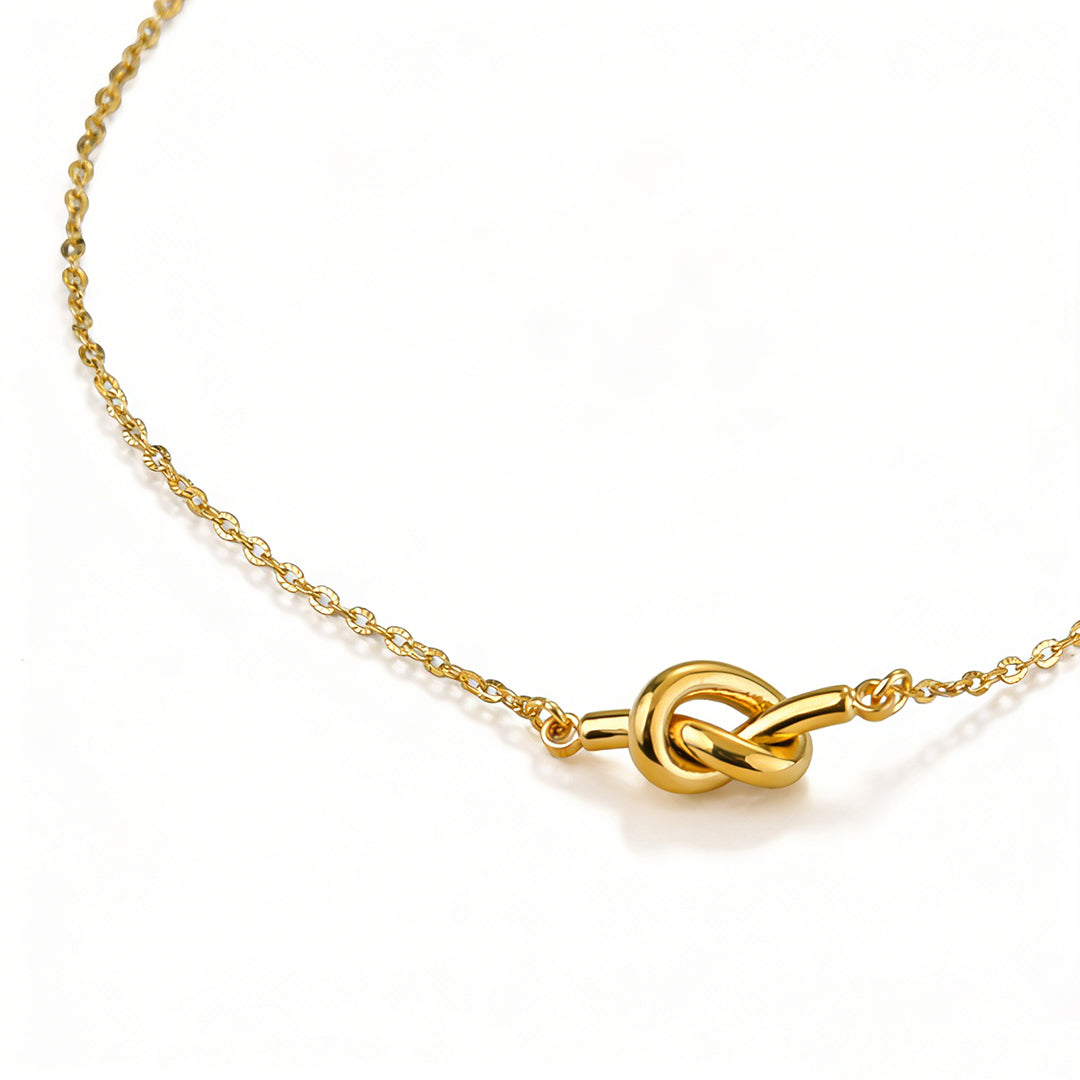 Minimalist gold pendant necklace styled for a modern layered jewelry look.