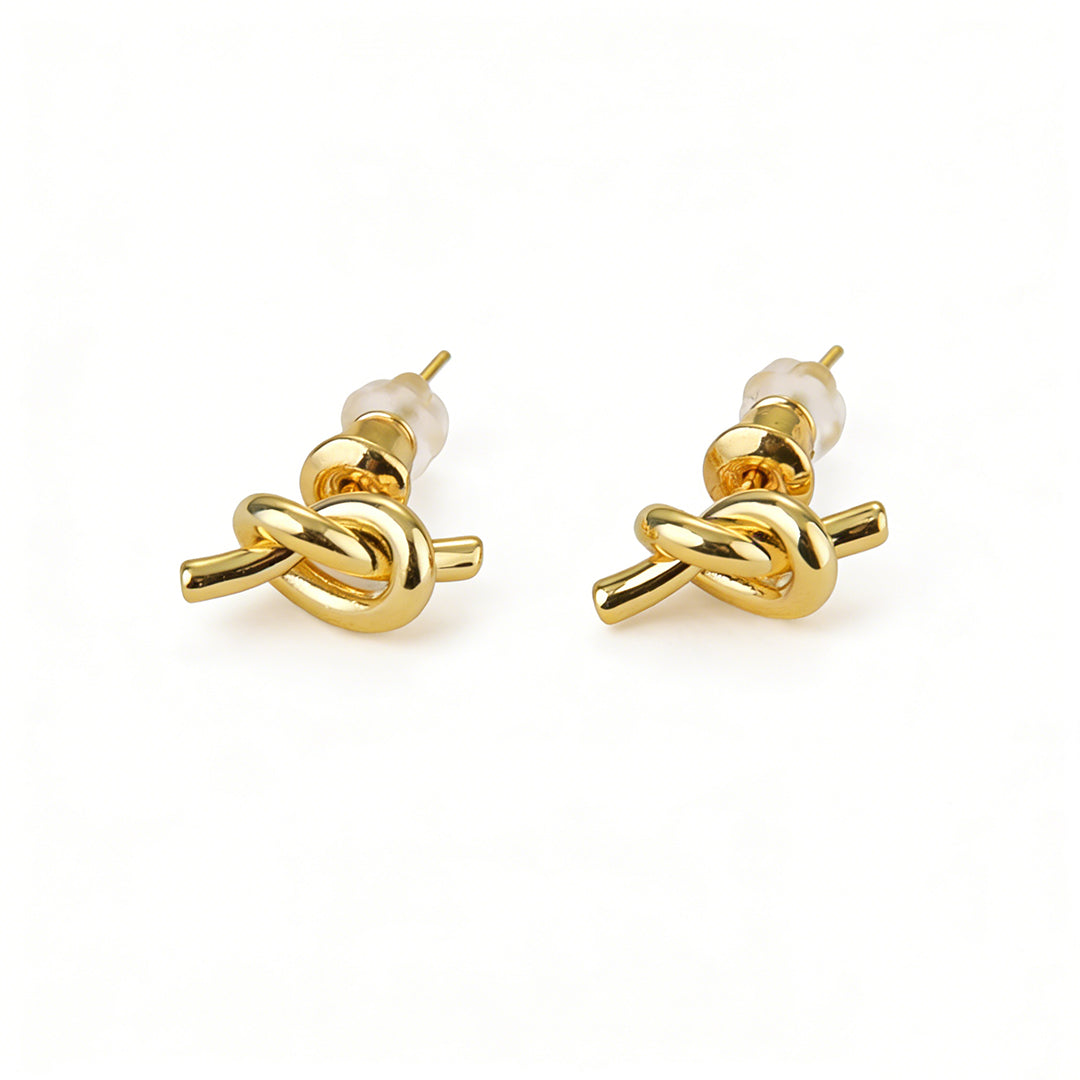 Dainty gold knot stud earrings, a classic minimalist jewelry piece for everyday professional wear.