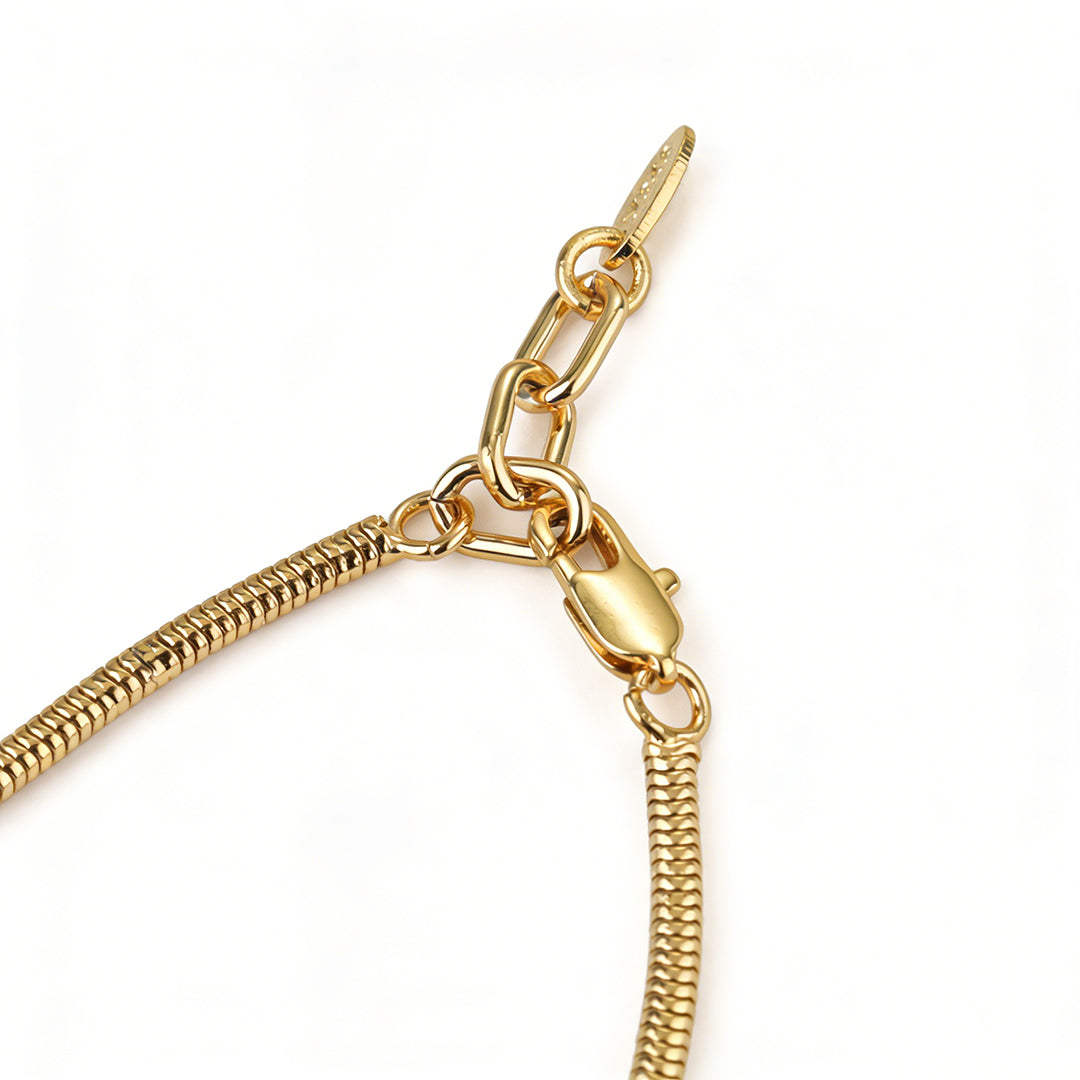 Flat lay of an edgy, minimalist gold chain bracelet for women, perfect for modern jewelry collections.
