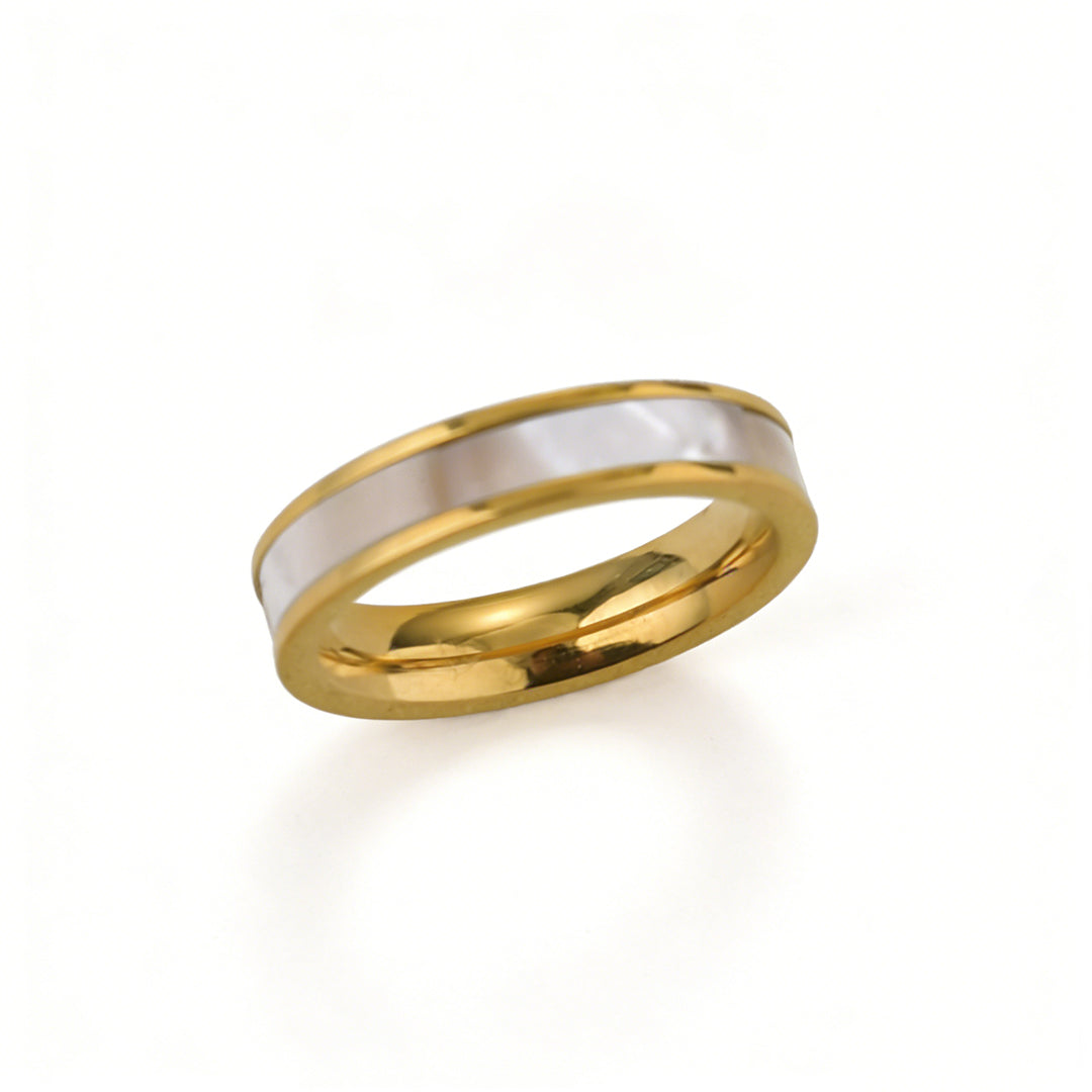 Modern minimalist mother of pearl ring with a sleek gold band, perfect for stackable jewelry styles.