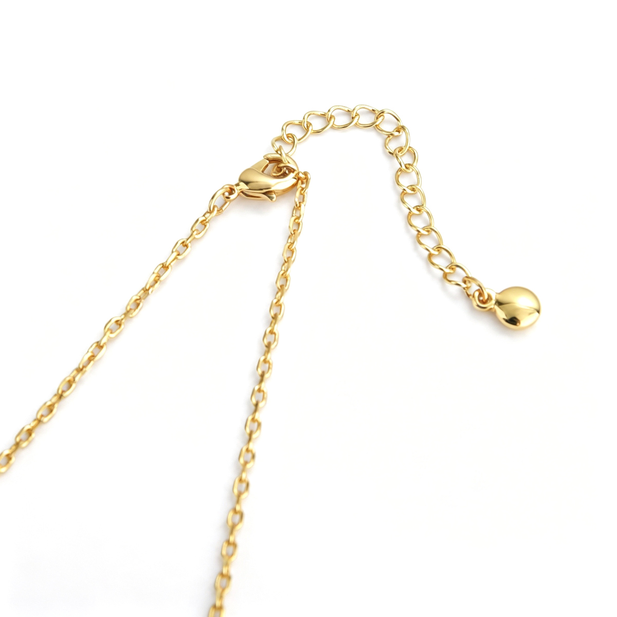 Cross pendant necklace shown from the front with colorful oval accents