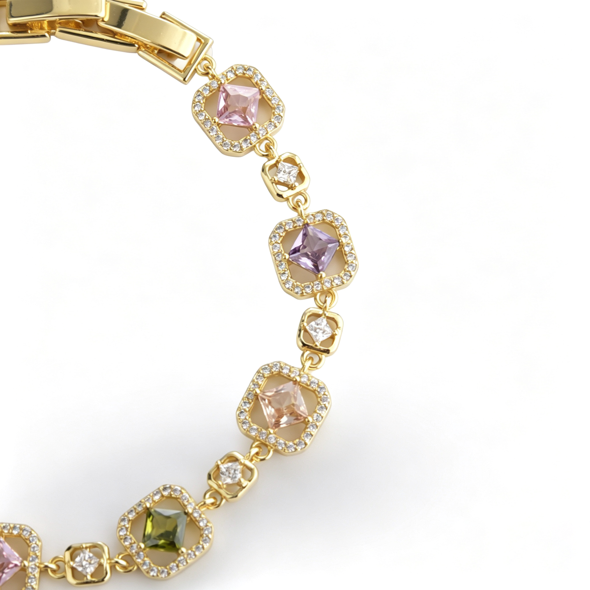 Curved view of a gold-plated station bracelet featuring vibrant pink, purple, and green cz stones.