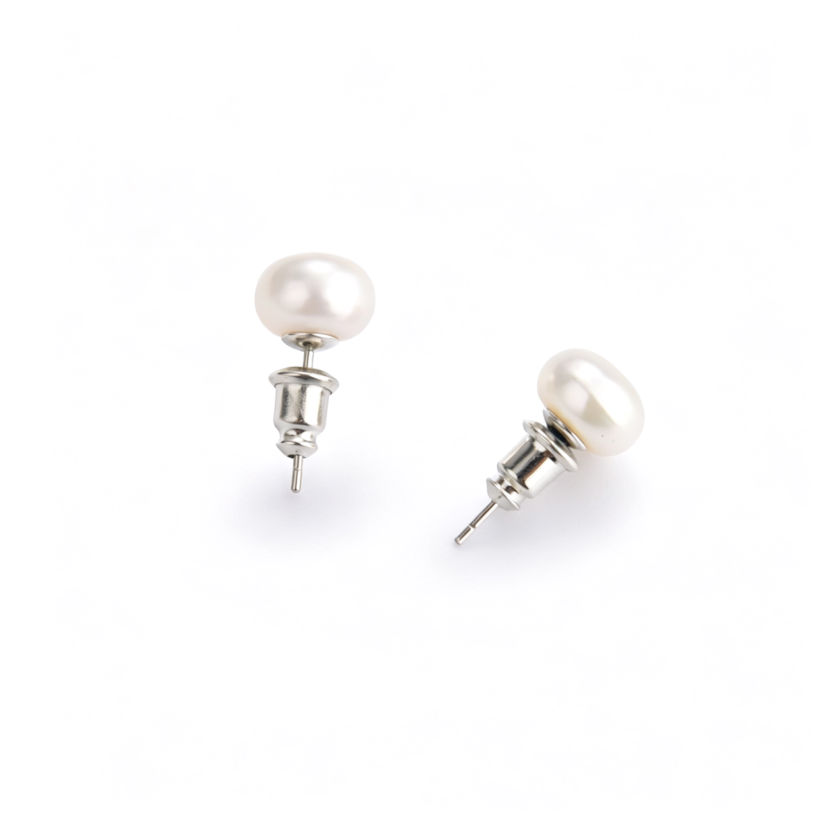 Close-up view of 0.9cm freshwater pearl stud earrings showing secure bullet clutch backings.