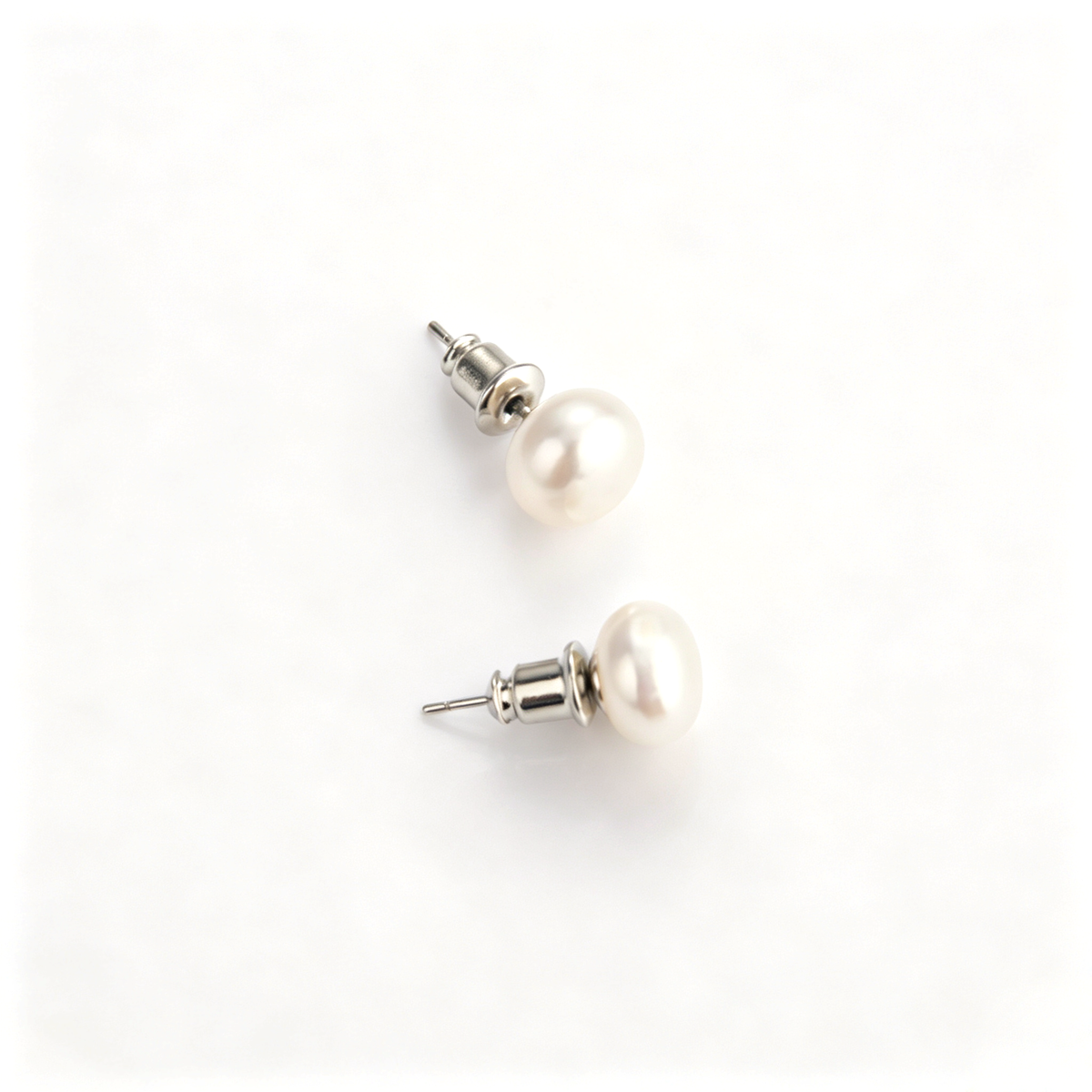 Top-down view of a pair of classic freshwater pearl stud earrings with S925 sterling silver posts.