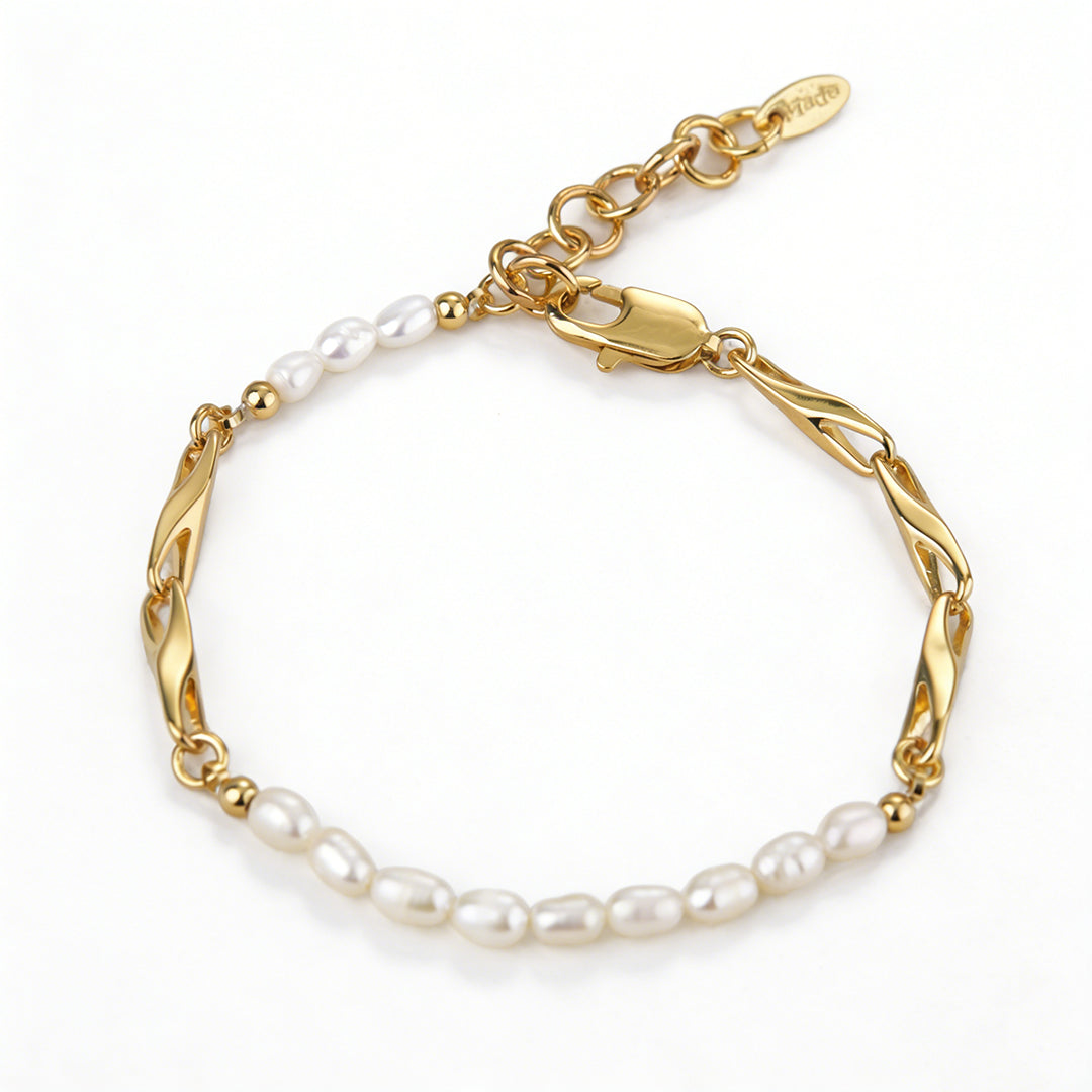 Close-up of a genuine natural oval pearl showing high luster on a radiant 18k gold plated chain.