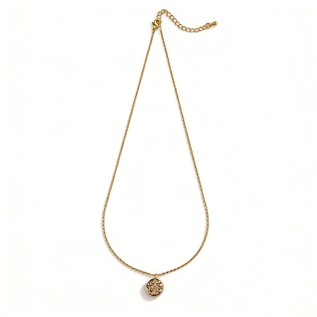 Ever P. North Star necklace featuring a vintage gold coin pendant with a starburst design.