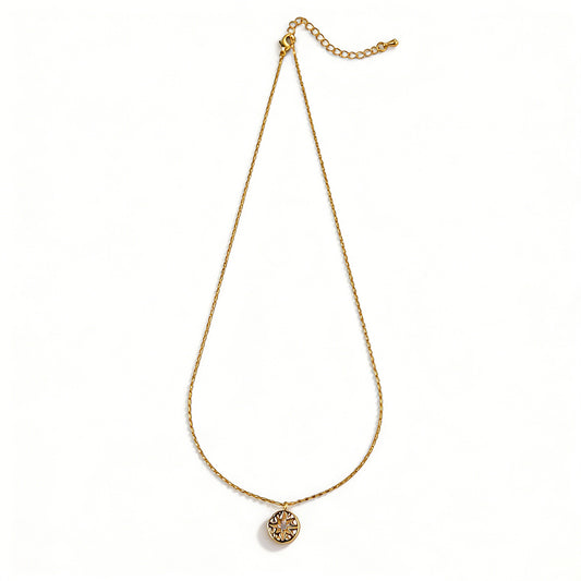 Ever P. North Star necklace featuring a vintage gold coin pendant with a starburst design.