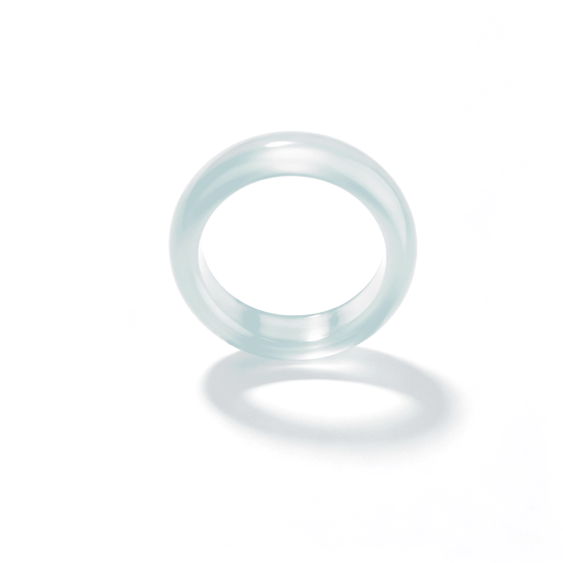 Side-angled view of a slim oily green chalcedony ring, highlighting its smooth hand-polished surface and minimalist natural stone aesthetic.