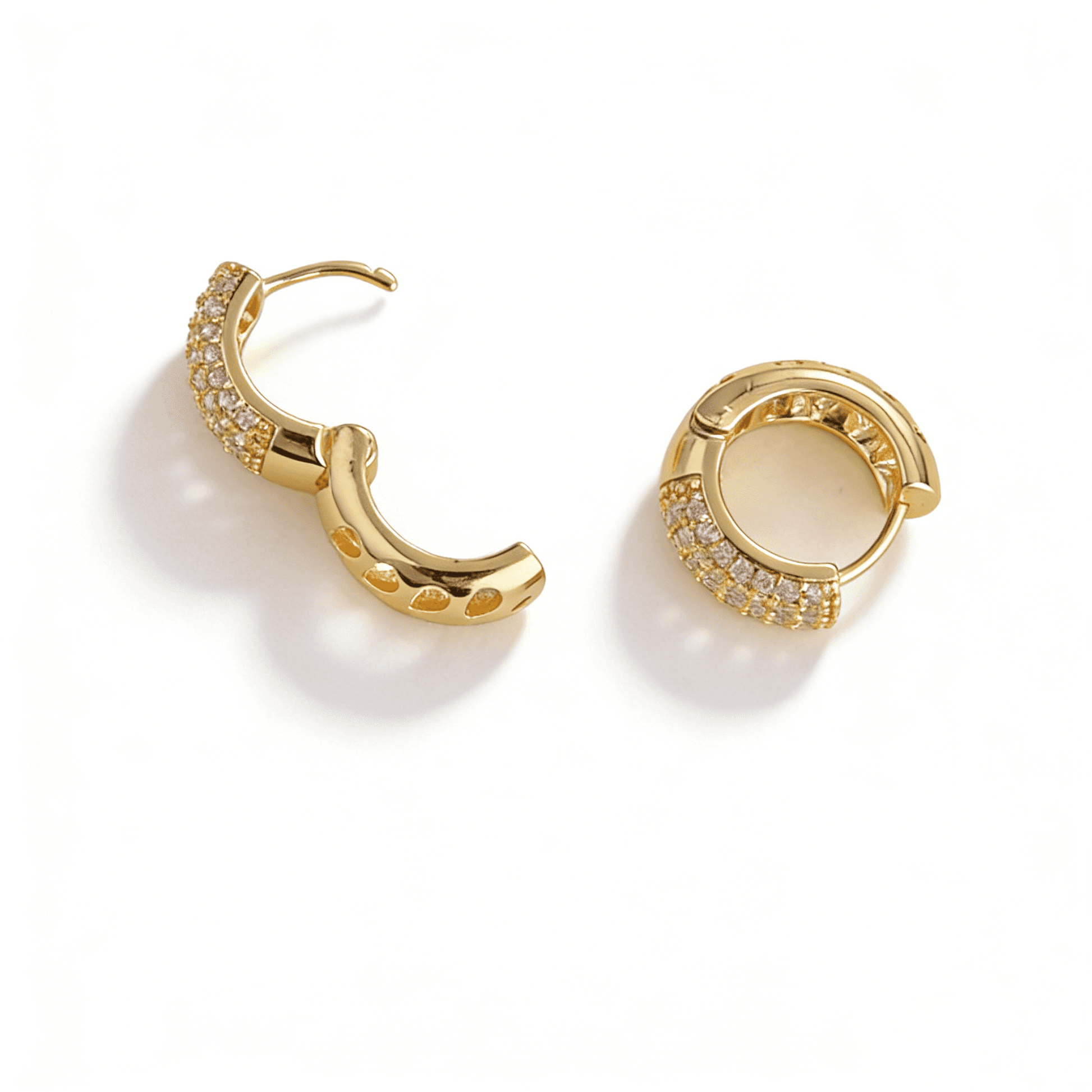 Detailed view of the open hinge clasp on Ever P. gold huggie hoops, ensuring a secure and comfortable fit.
