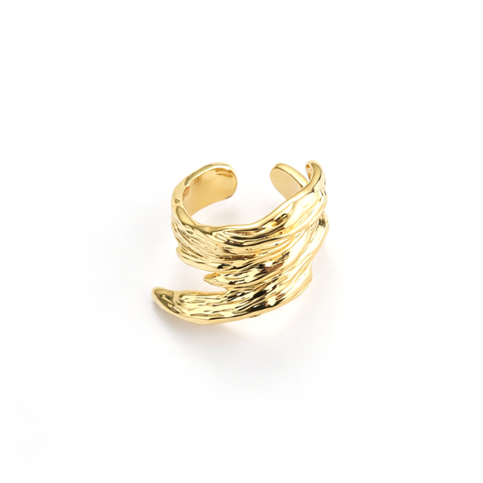 Sculptural open cuff ring with layered wave bands in an angled view