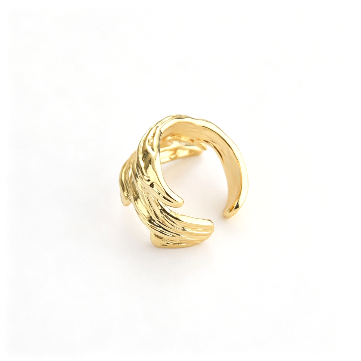 Layered wave cuff ring shown from the side, highlighting its curved overlapping bands