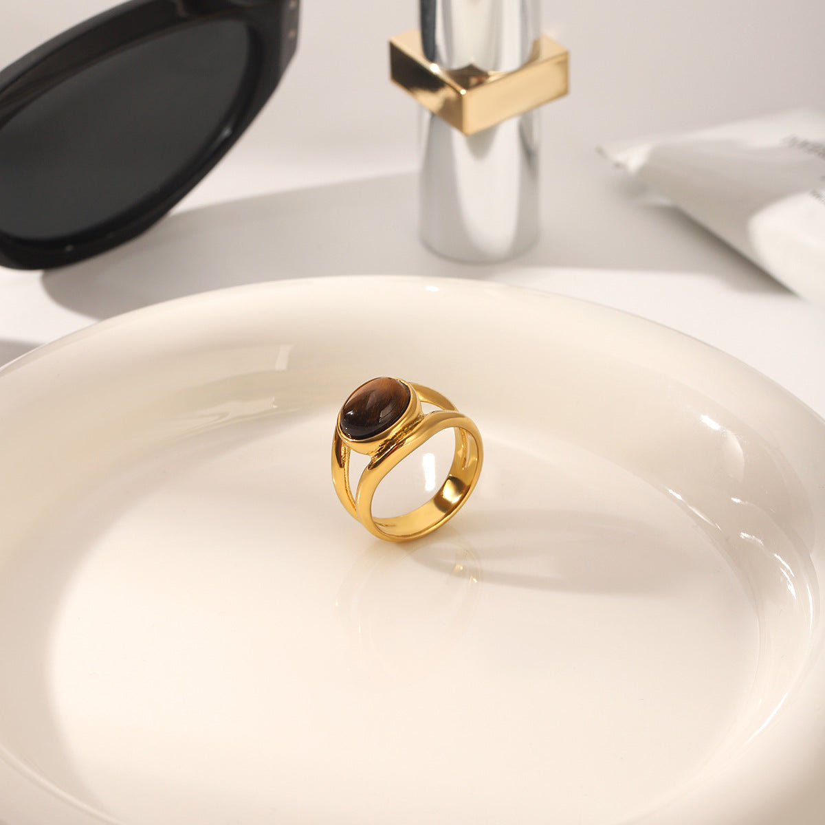 The oval centerpiece ring shown on a white bathroom counter beside a sink and faucet.