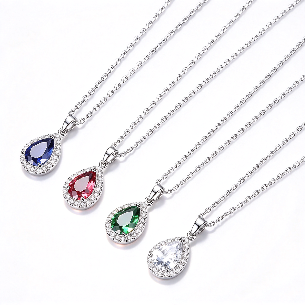 Pear-shaped halo pendant necklaces in blue, red, green, and clear color options displayed together.