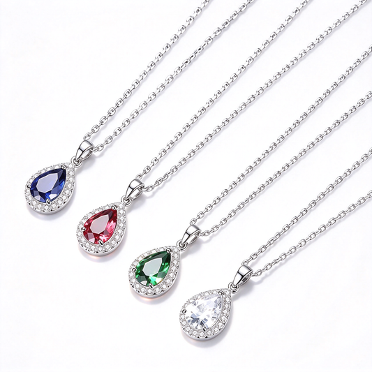 Pear-shaped halo pendant necklaces in blue, red, green, and clear color options displayed together.