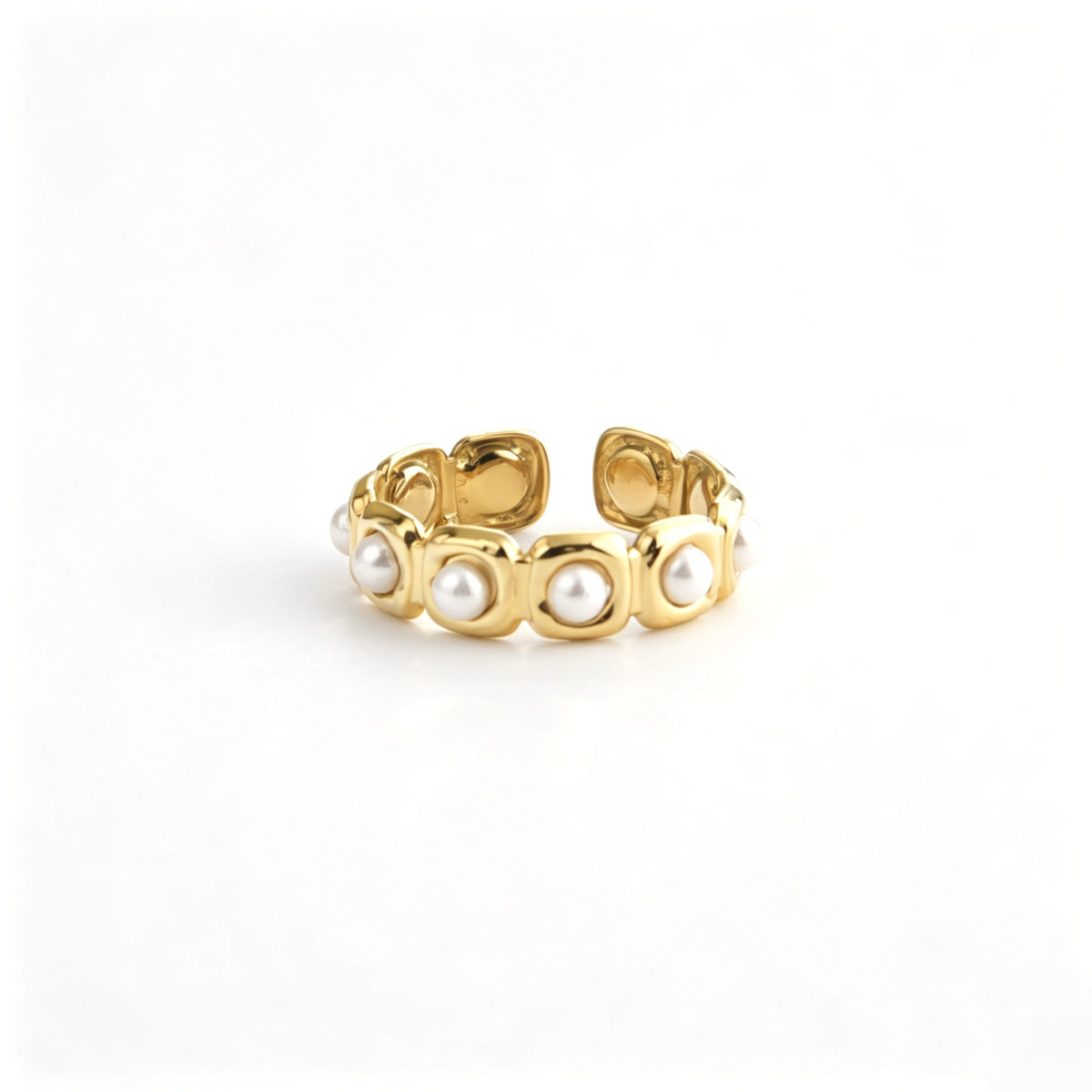 Open cuff ring viewed from above, highlighting the repeating rounded settings and pearl accents