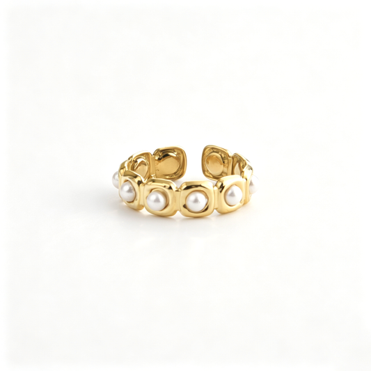 Open cuff ring viewed from above, highlighting the repeating rounded settings and pearl accents