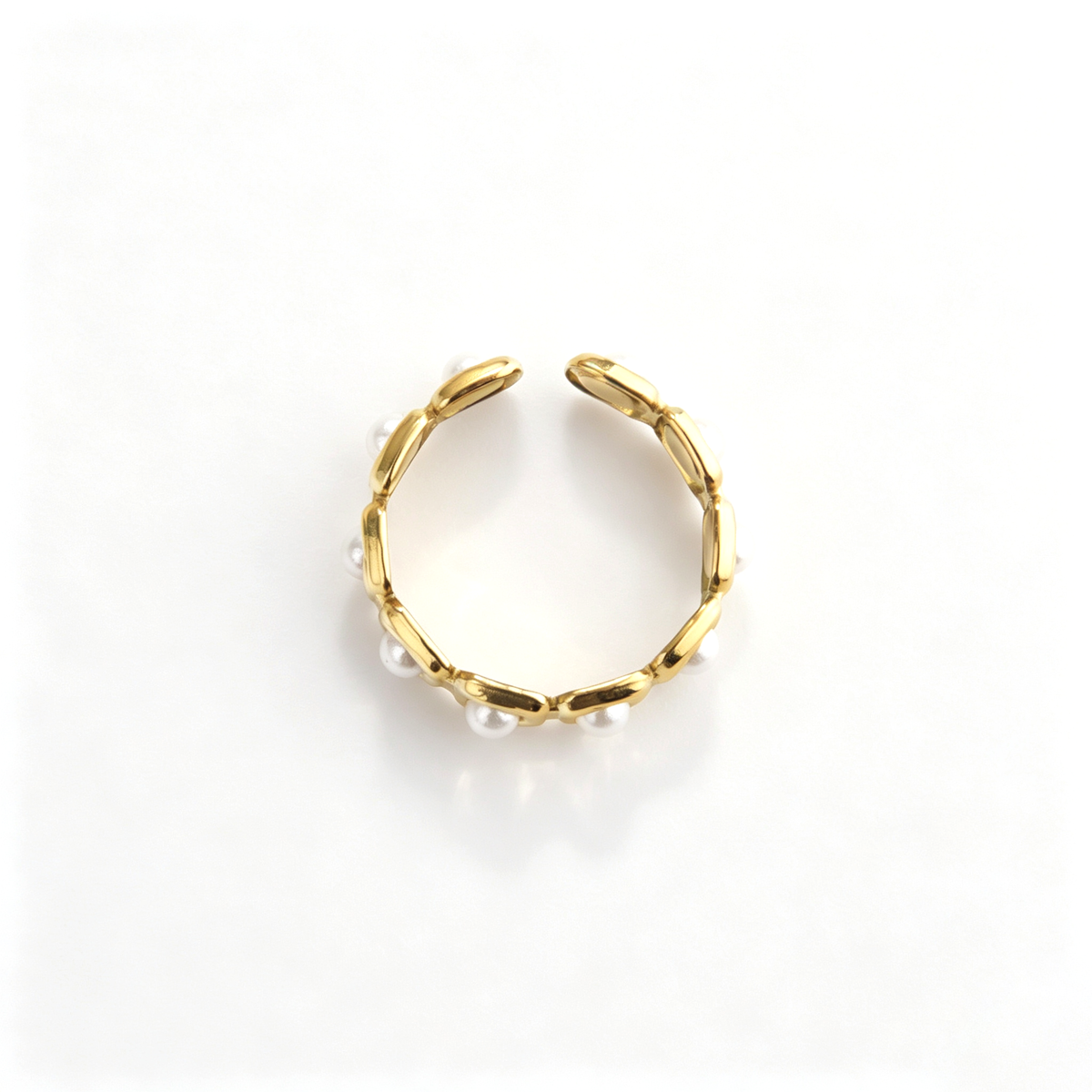 Open cuff ring shown from a three-quarter front view with repeating pearl accents