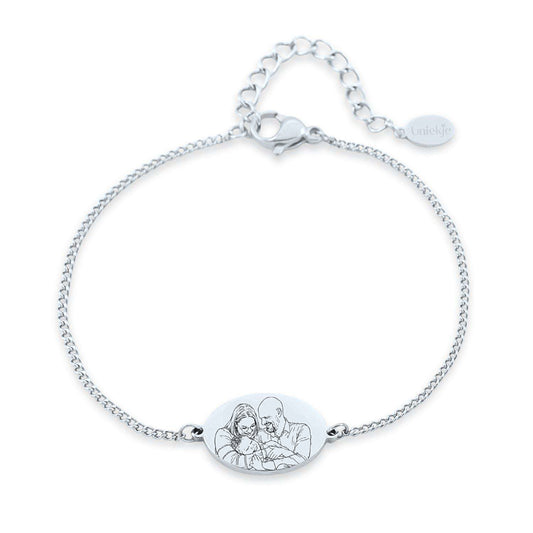 Front view of engraved family bracelet in silver-tone appearance featuring an oval charm with custom portrait artwork