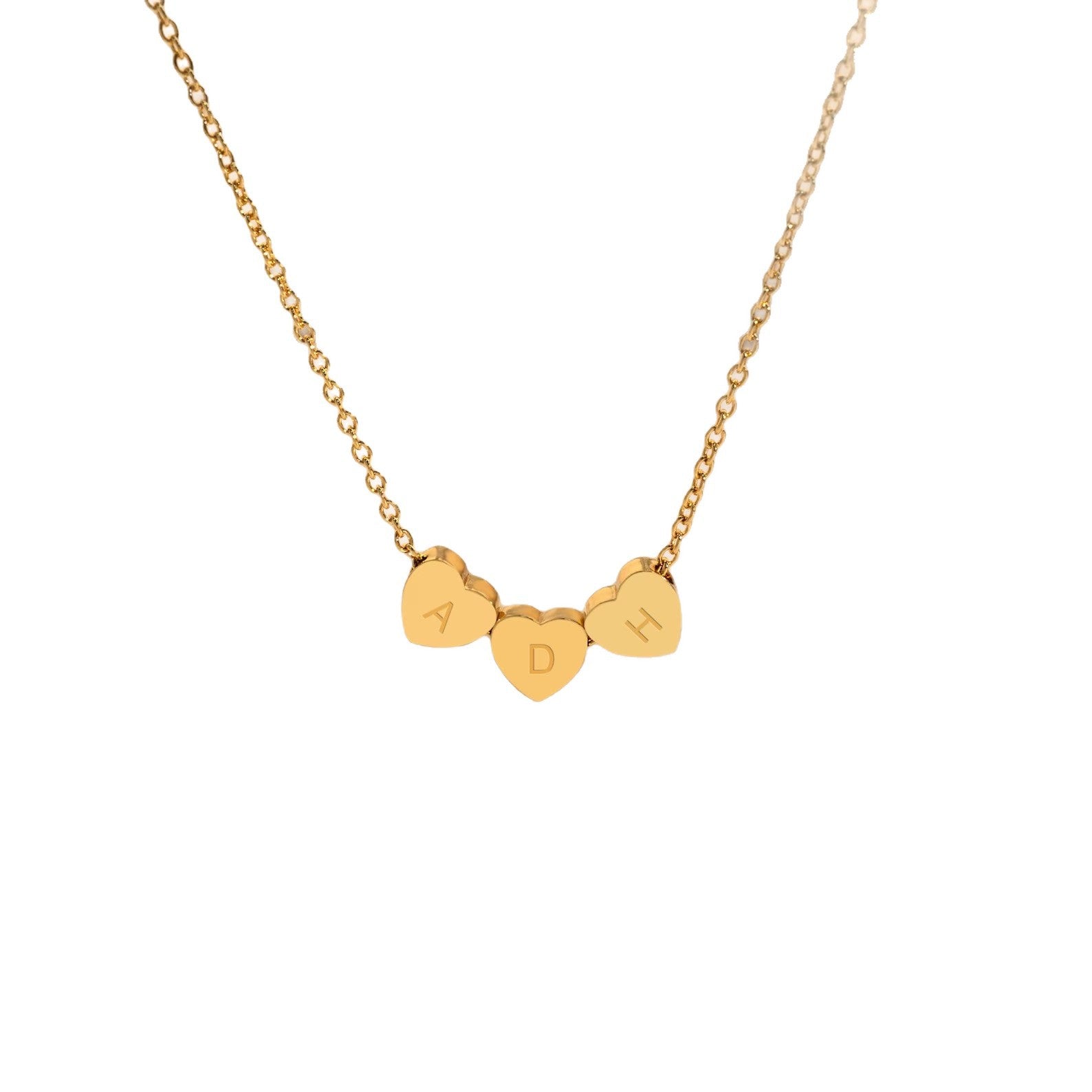Personalized heart necklace with three engraved charms on a white background.