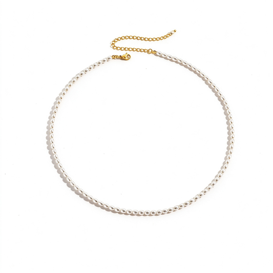 Petite pearl bead necklace arranged in a curved strand with a gold-tone clasp on a white background.