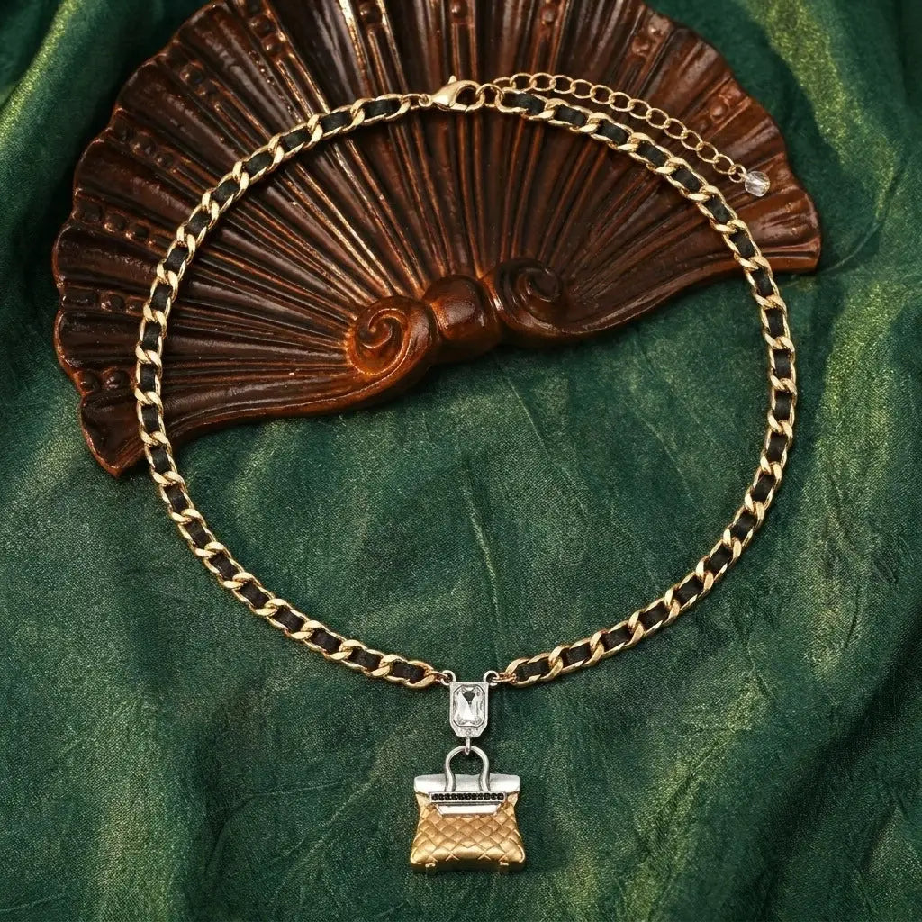 Studio product shot of the adjustable quilted bag charm choker necklace isolated on a clean white background.