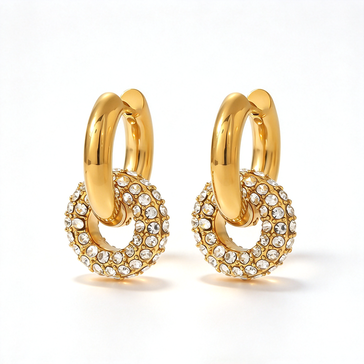 Gold-tone hoop earrings with clear decorative accents shown from the front.