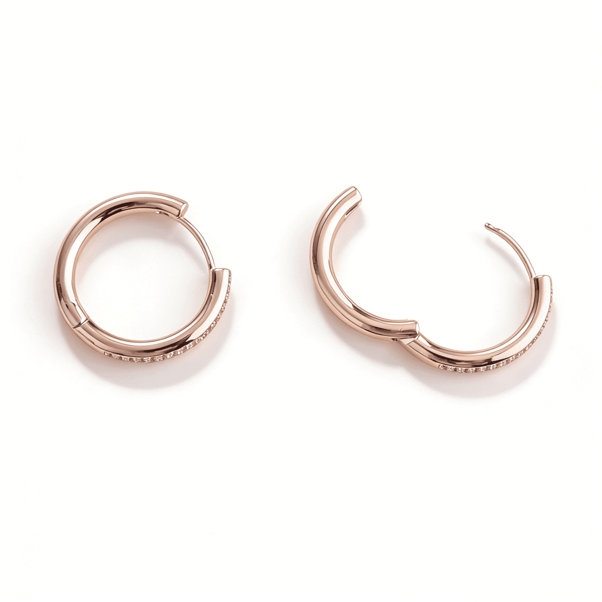 Detailed view of the secure hinged click-down clasp on the rose gold pave eternity hoops.