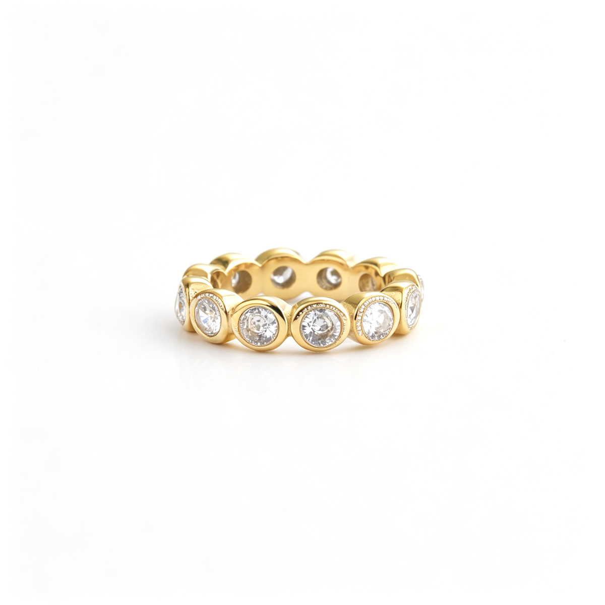 Round band ring shown from a low front angle with repeated raised circular details