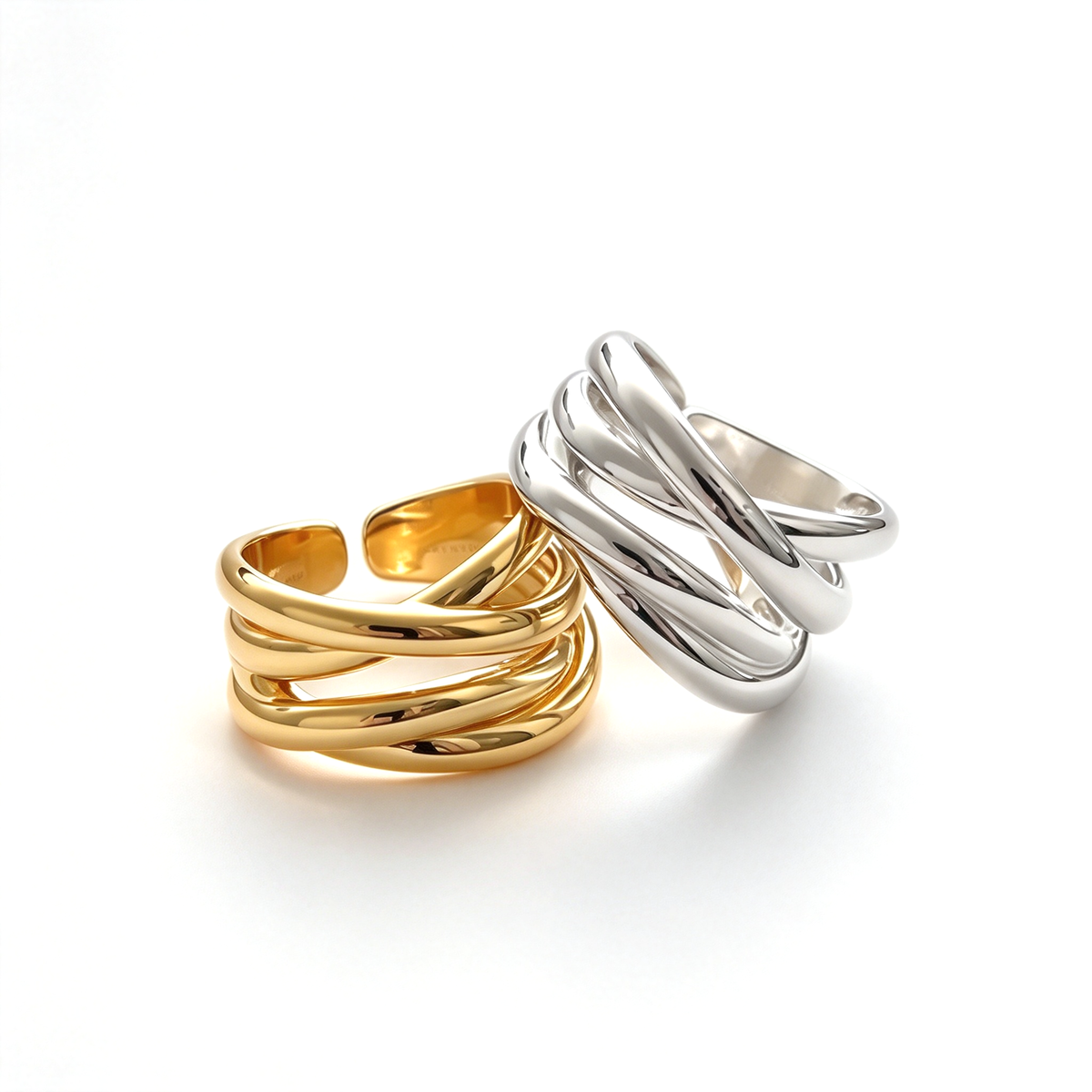 Hand wearing a sculptural crossover ring with layered curved lines