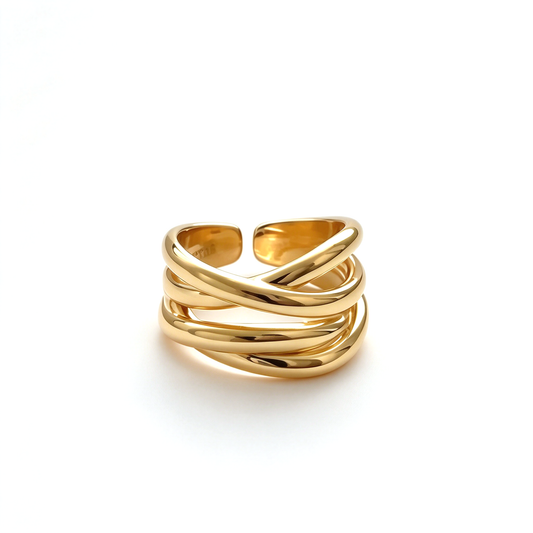 Gold-tone and silver-tone sculptural crossover rings shown side by side on a white background