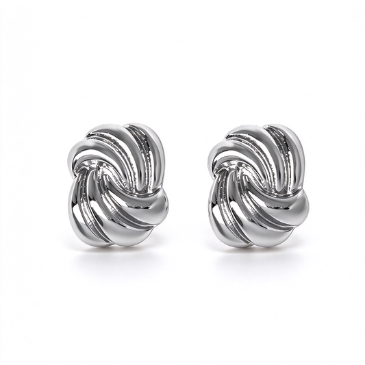 Silver-tone sculptural knot stud earrings featuring an interwoven design with dimensional curved details.