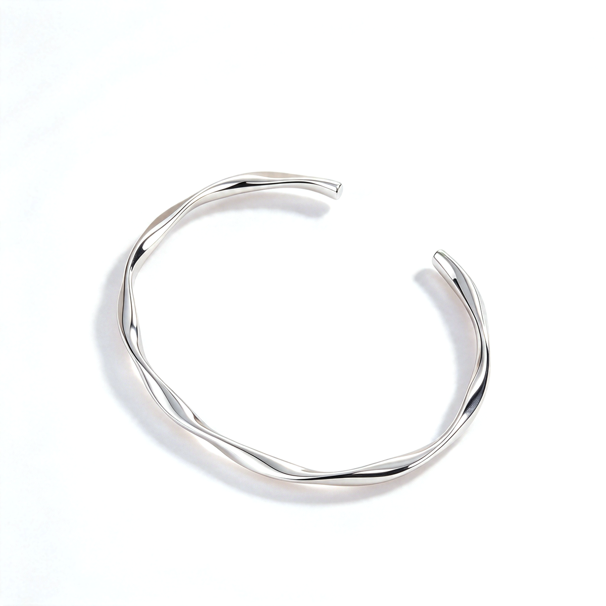 Silver tone open cuff bracelet shown alone against a white background