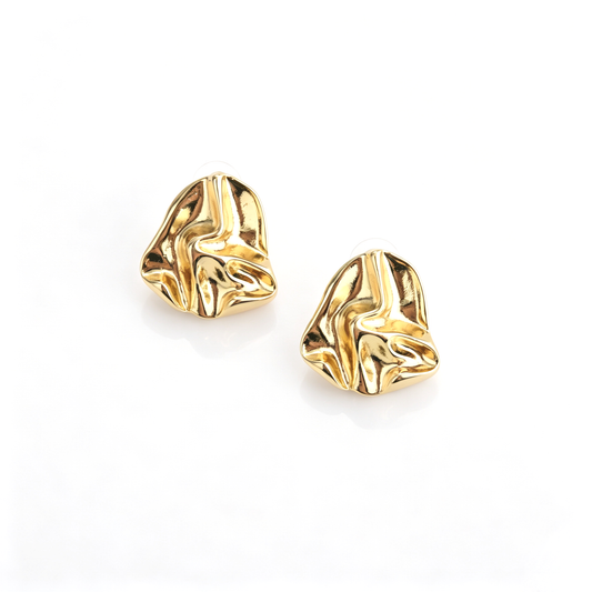 Top-down view of a pair of gold-tone organic folded metal statement stud earrings