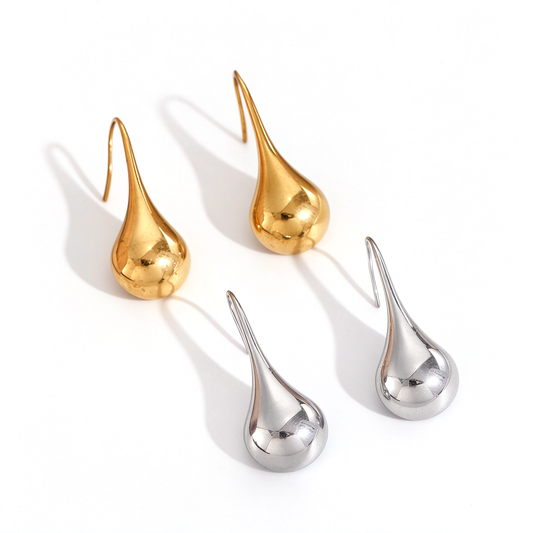 Sculptural teardrop dangle earrings in gold-tone and silver-tone, displayed on a white background.