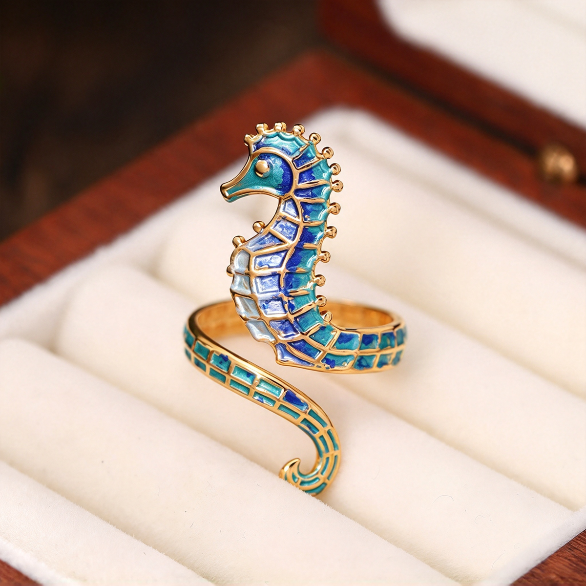 Blue seahorse wrap ring displayed upright in a jewelry presentation setting