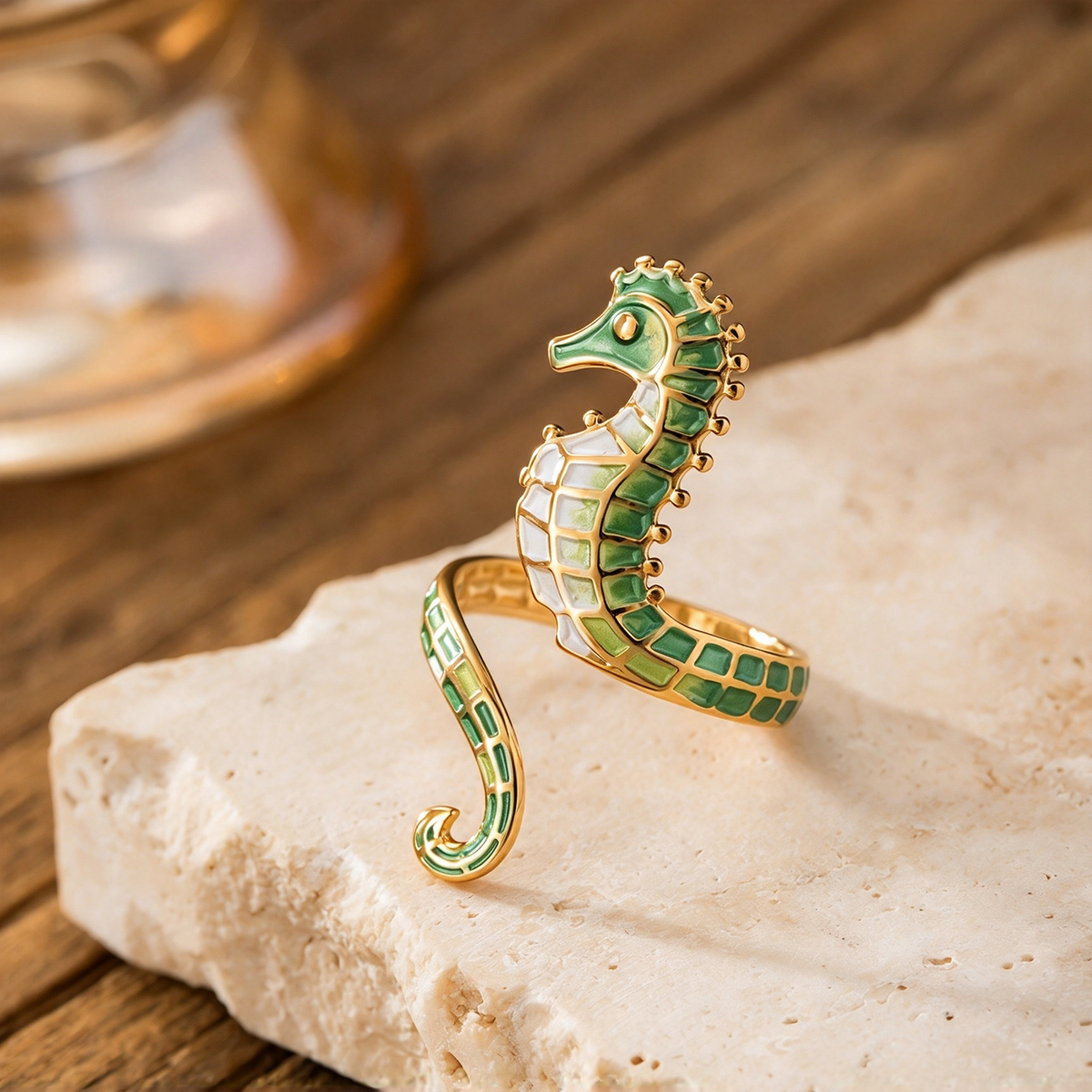 Green seahorse ring with light-colored segmented details shown on a cream stone surface