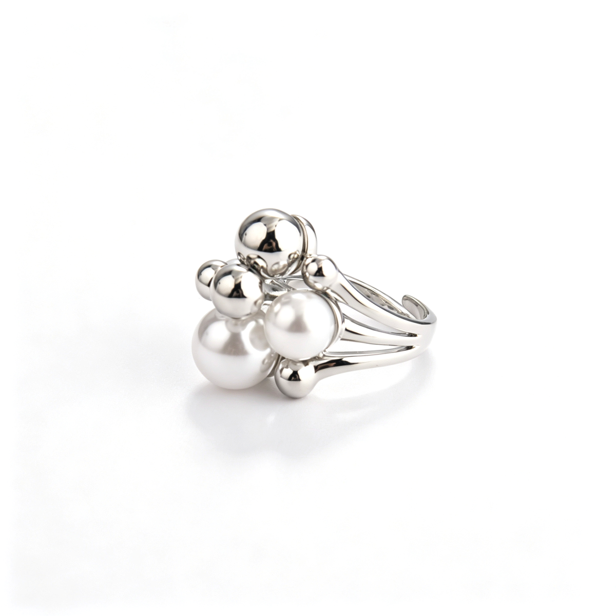 Profile angle of silver open ring highlighting multi-layered pearl and metal ball cluster.