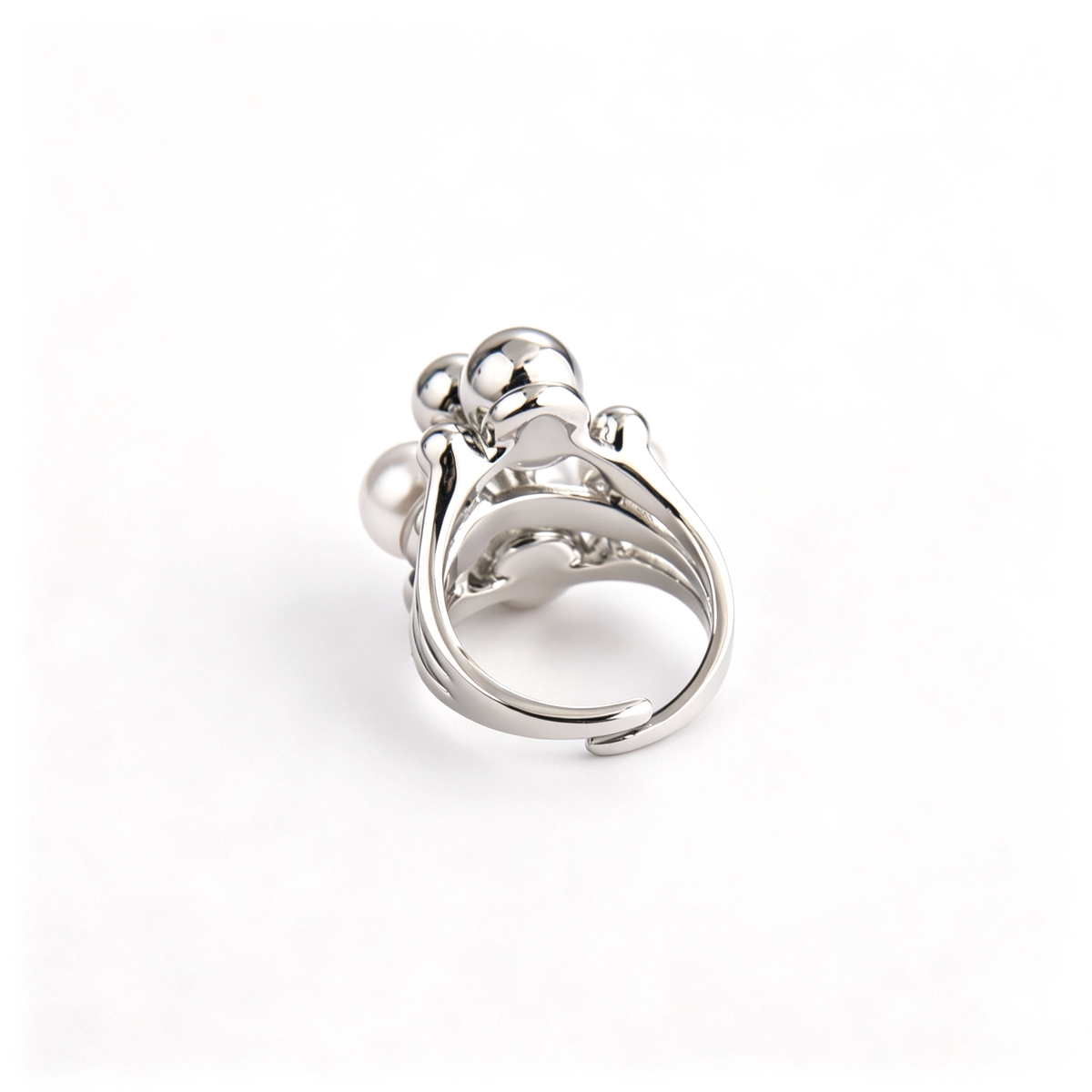 Back perspective view of silver statement ring showing the open adjustable band structure.
