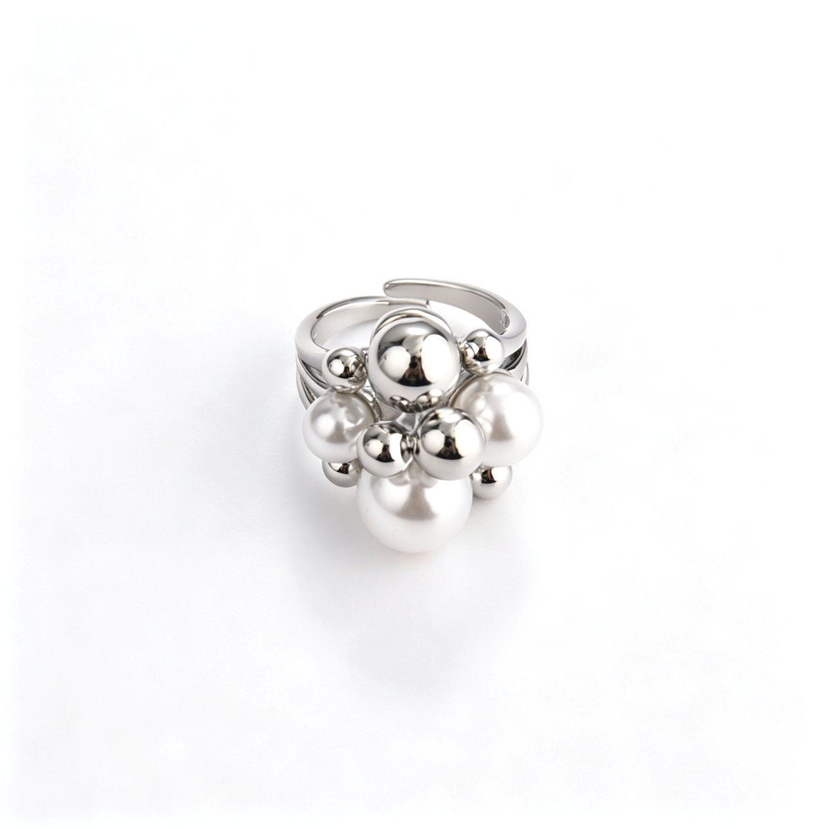 Overview of silver-tone bubble cluster ring with faux pearls set against a clean white background.