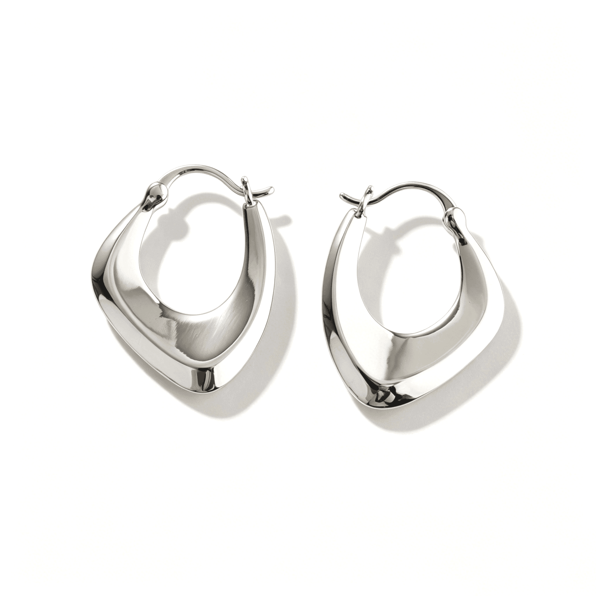 Large silver hoops by Ever P. featuring a unique 3.2cm sculptural intertwined silhouette.