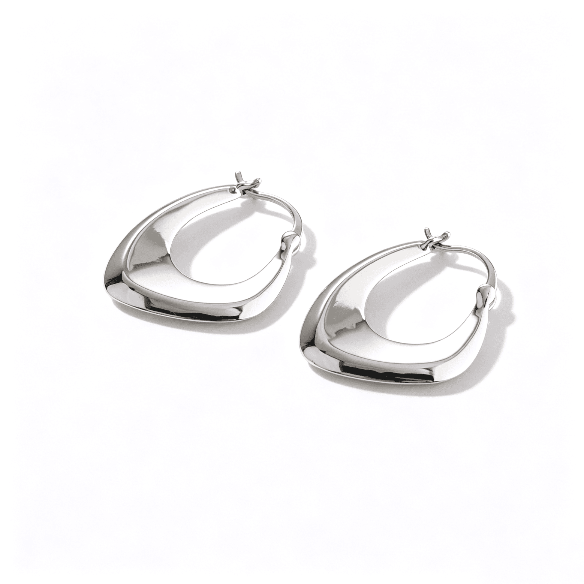 Detailed view of twisted hoop earrings with a fluid architectural style from Ever P. Jewelry.