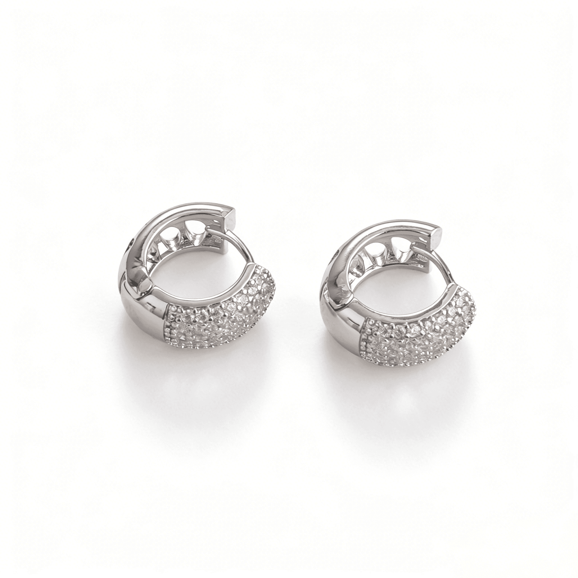 A pair of lustrous silver plated small hoop earrings featuring dense micro-pave cubic zirconia for evening radiance.