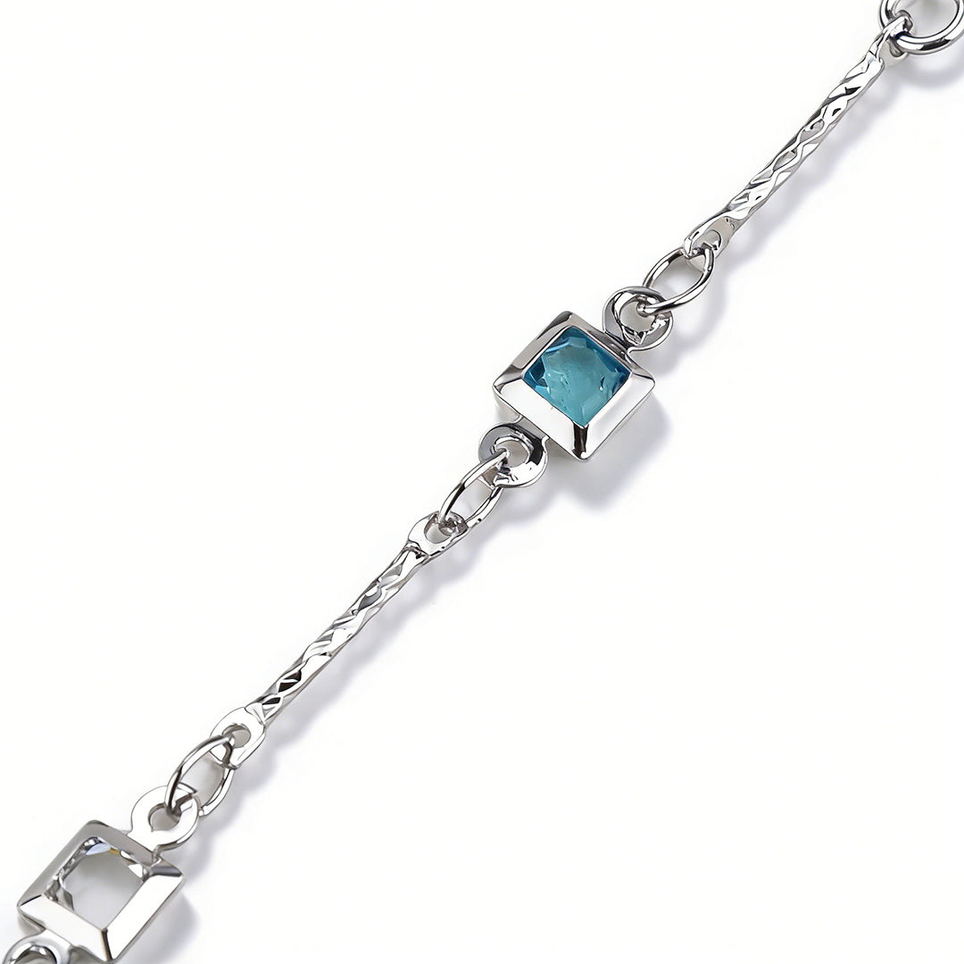 Detailed view of the sparkling solitaire CZ charm on a sleek silver-tone minimalist bracelet.