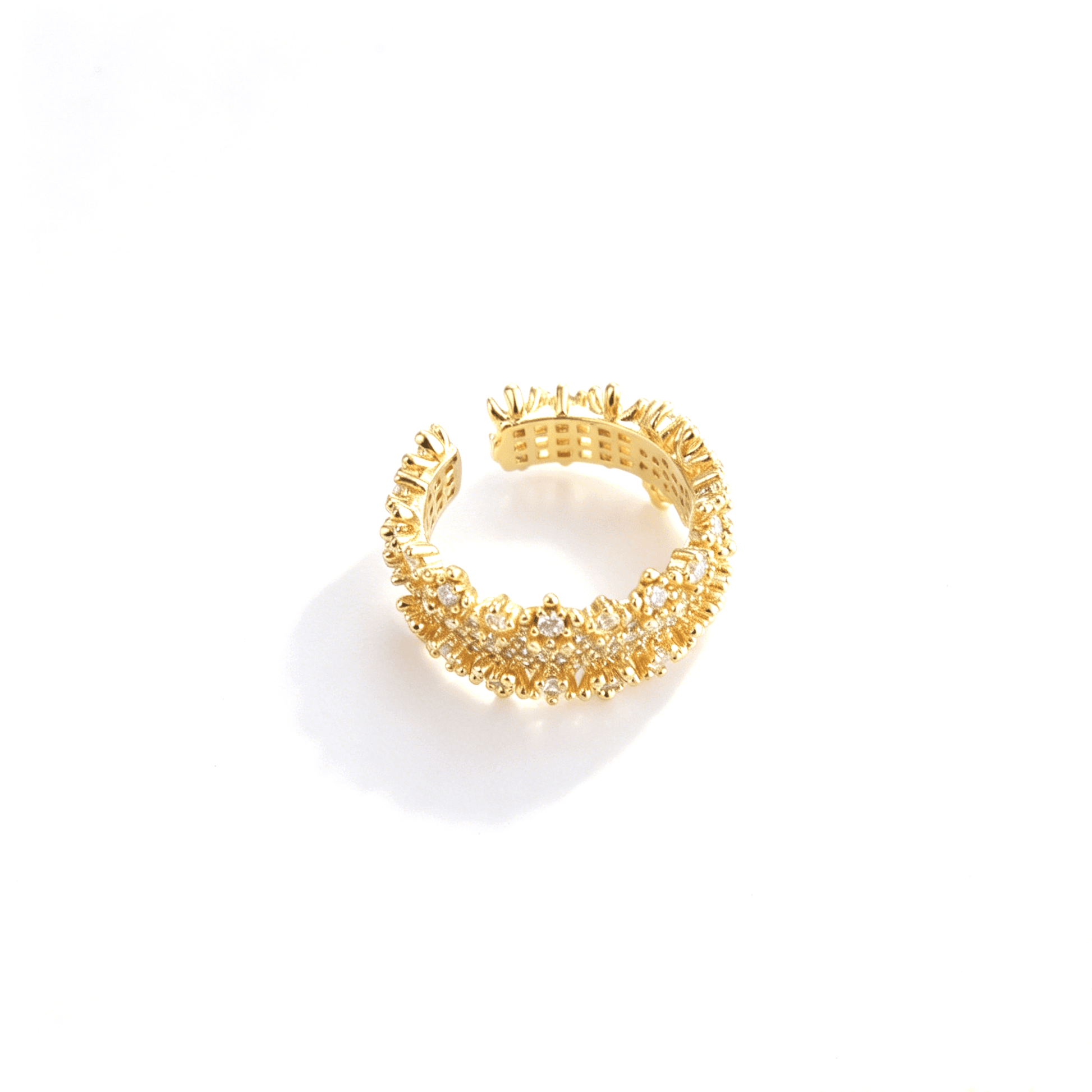 Close-up angled view highlighting the luxurious warm tone and brilliant pave setting of the gold-plated adjustable CZ band ring.