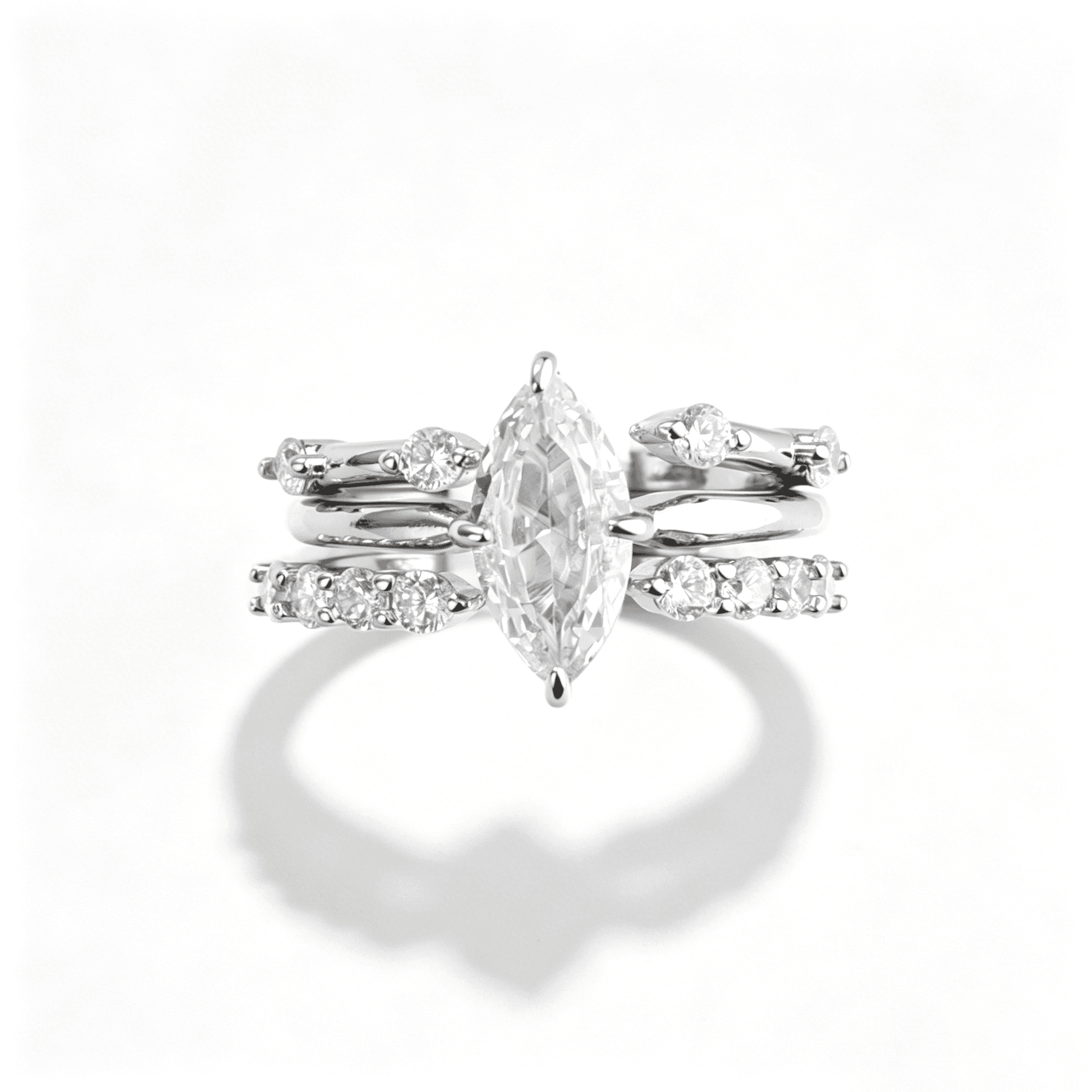 Overhead view of a 3-in-1 stackable ring set separated to show the marquise center ring and decorative side bands.