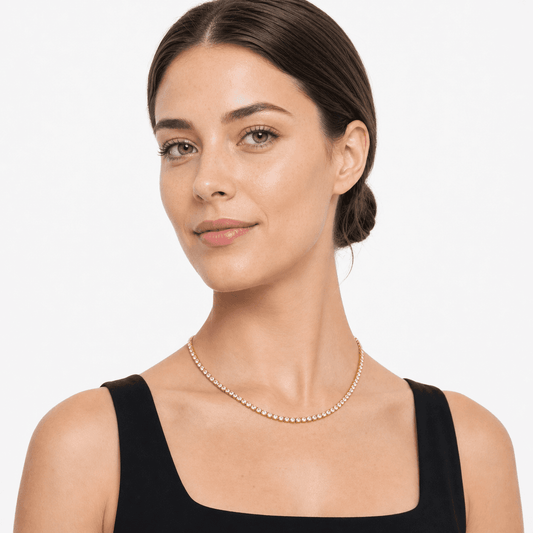 Woman wearing a gold-tone stainless steel tennis necklace with 4 mm clear stones