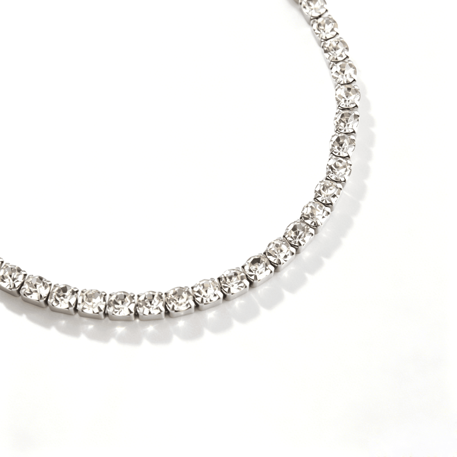 Close-up of clear round cubic zirconia stones in silver-tone square settings