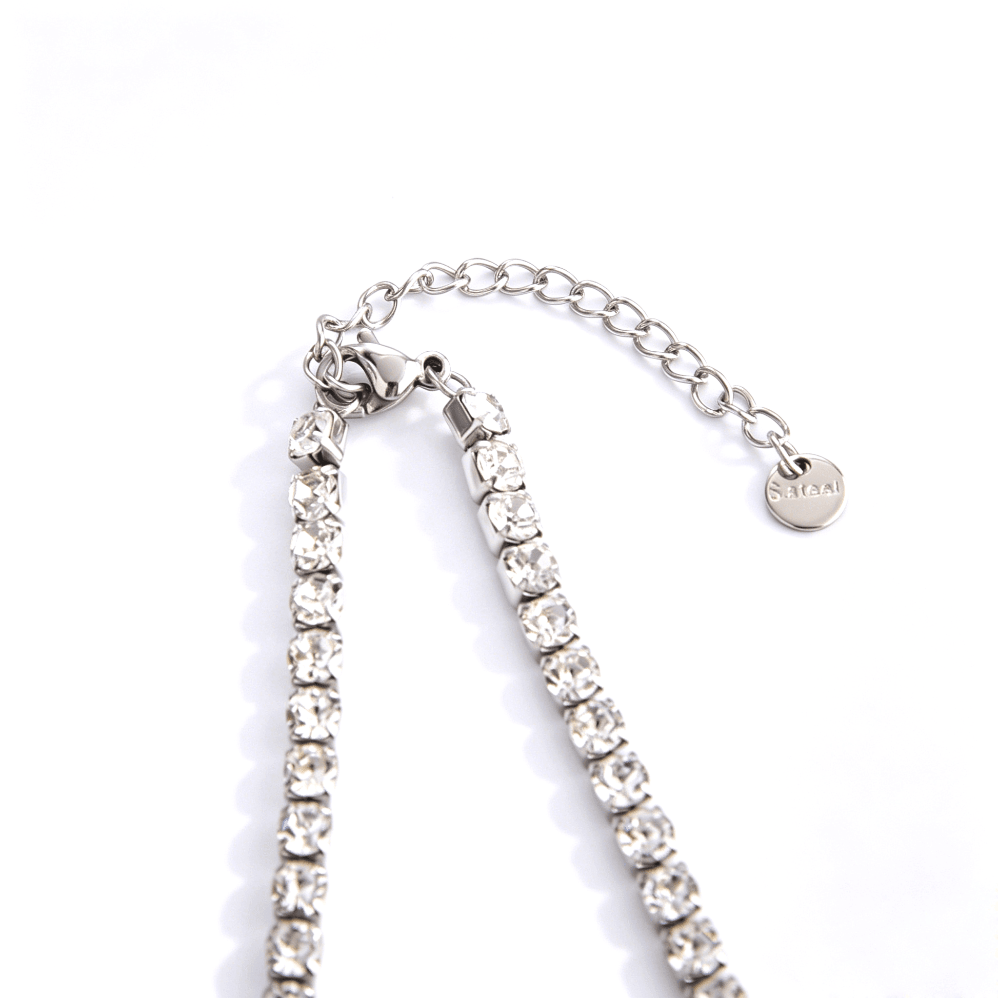 Silver-tone tennis necklace lobster clasp, extender links, and end tag