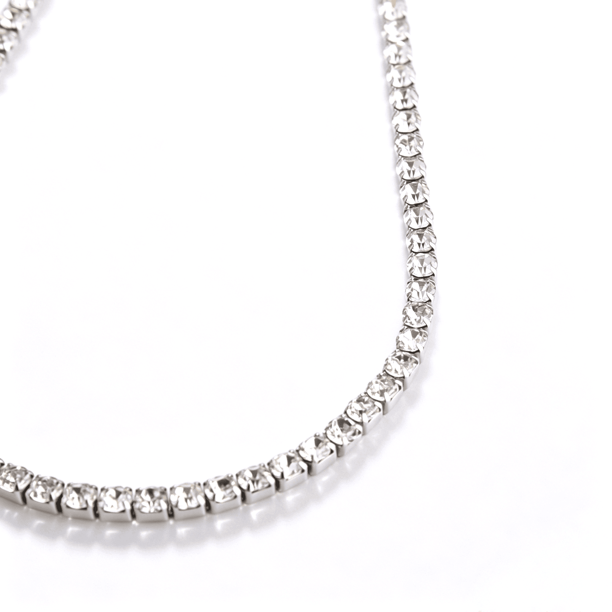 Angled detail of the silver-tone stone-set tennis necklace chain